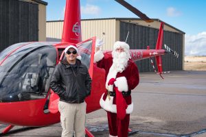 Guidance Aviation Pilot Zach Hardwick with Santa Claus and a Robinson R66